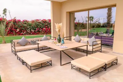 a patio with a table and chairs and a patio at Villa des sœurs bradaa in Marrakech