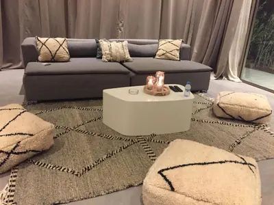 a living room with a couch and a table at Villa Jamila -Villa de luxe a Marrakech in Marrakech