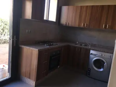 a kitchen with a stove and a washing machine at Villa Jamila -Villa de luxe a Marrakech in Marrakech