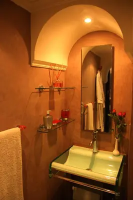 a bathroom with a sink and a mirror at Riad Carllian in Marrakech