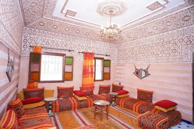 a living room with couches and a chandelier at Hostel Essassi 23 in Marrakech