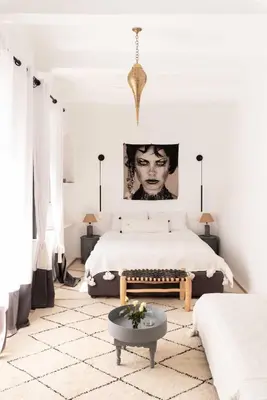 a white bedroom with a bed and a table at RIAD MAGIE Boutique Hotel in Marrakech