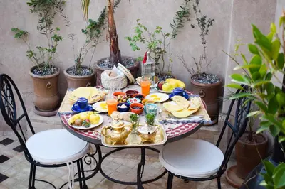 a table with a plate of food on it at Riad Vis Ta Vie in Marrakech