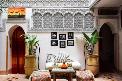 a living room with a table and chairs at Riad Vis Ta Vie in Marrakech