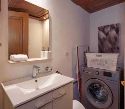 a bathroom with a sink and a washing machine at Appartement Haut Standing Gueliz Plaza avec Vue in Marrakech