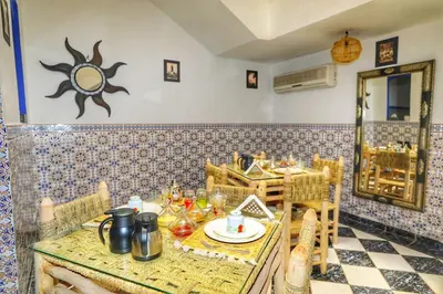a dining room with a table and a mirror at Riad Amirkesh and Pool in Marrakech