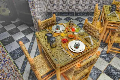 a table with plates of food on top at Riad Amirkesh and Pool in Marrakech