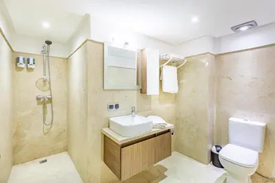 a bathroom with a toilet and a sink and a shower at Royal Deluxe Gold - Marrakech, Luxe Pool View in Marrakech