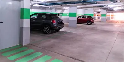 a parking garage with two cars parked in it at Royal Deluxe Gold - Marrakech, Luxe Pool View in Marrakech