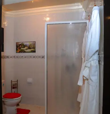 a bathroom with a shower and a toilet at Hôtel La Citta Rossa in Marrakech