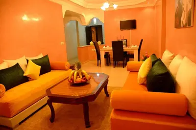 a living room with two couches and a table at Hôtel La Citta Rossa in Marrakech
