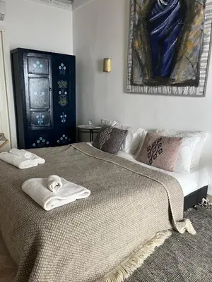 a bedroom with a large bed with towels on it at Riad Siena II in Marrakech
