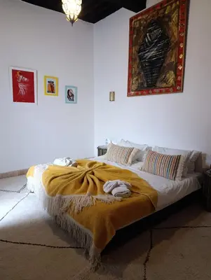 a bedroom with a bed with a blanket on it at Riad Siena II in Marrakech