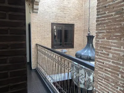a balcony with a vase on the side of a building at Riad luna in Marrakech