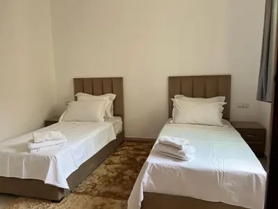a bedroom with two beds with white sheets at Perfect only family apartment & air cooling in Marrakech