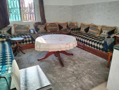 a living room with couches and a table at Perfect only family apartment & air cooling in Marrakech