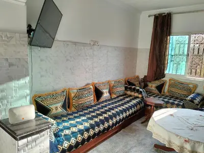 a living room with a couch with pillows on it at Perfect only family apartment & air cooling in Marrakech