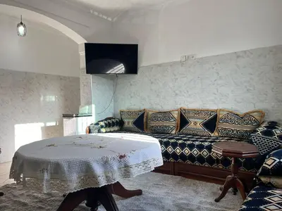 a living room with a couch and a table at Perfect only family apartment & air cooling in Marrakech