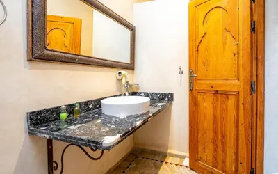 a bathroom with a sink and a mirror at Riad Citronnelle in Marrakech