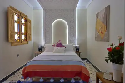 a bedroom with a large bed in a room at Riad Banatti in Marrakech