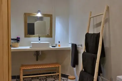 a bathroom with a sink and a mirror at Riad Banatti in Marrakech