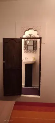 a bathroom with a sink and a mirror at Riad Dar Zaida in Marrakech