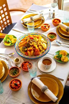 a table with a plate of food on it at Riad villa saphir & SPA in Marrakech