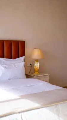 a bedroom with a bed and a lamp on a table at Riad villa saphir & SPA in Marrakech