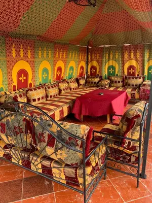 a dining room with a table and chairs at Appartment Khadija in Marrakech
