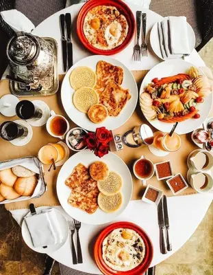 a table with plates of breakfast food on it at Appartment Khadija in Marrakech