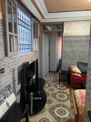 a living room with a tv and a couch at Appartment Khadija in Marrakech