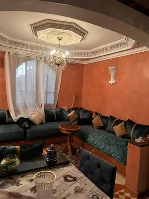 a living room with a couch and a chandelier at Appartment Khadija in Marrakech
