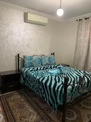 a bedroom with a zebra print bed in a room at Appartment Khadija in Marrakech