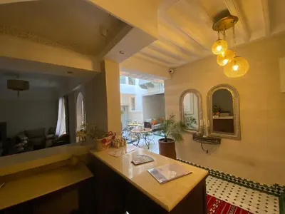 a living room with a table and a couch at Riad Magnolia&SPA in Marrakech