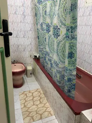 a bathroom with a toilet and a shower curtain at APPARTEMENT PERLE RARE AU CENTRE DE MARRAKECH in Marrakech