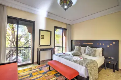 a bedroom with a bed and a large window at VILLA Garden in Marrakech