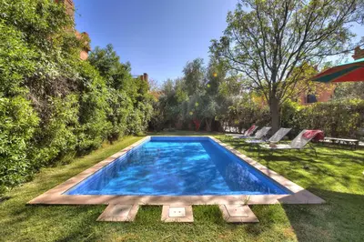 a swimming pool in the middle of a yard at VILLA Garden in Marrakech