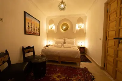 a bedroom with a bed and a door and a rug at Riad El Habib in Marrakech