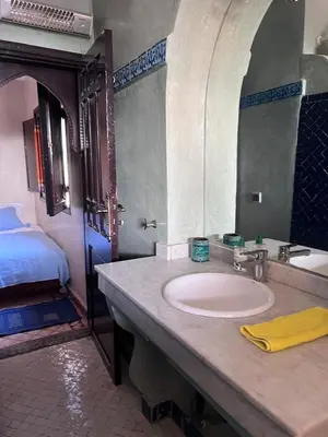 a bathroom with a sink and a bed at Villa Aalama in Marrakech