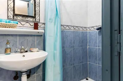 a bathroom with a sink and a shower at Très Beau Riad à Marrakech avec piscines in Marrakech