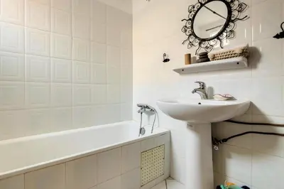 a bathroom with a sink and a tub and a mirror at Très Beau Riad à Marrakech avec piscines in Marrakech