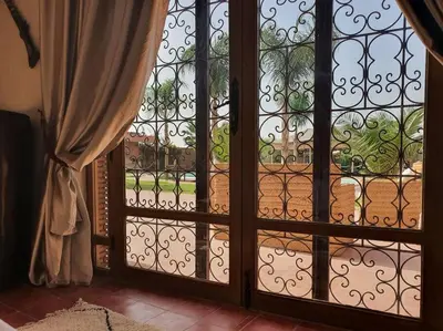 an open door with a view of a garden outside at RIAD - Jnan Bnati - Pool in Marrakech