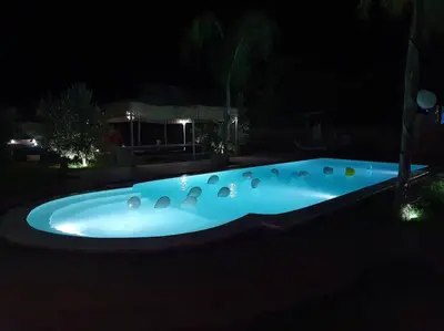 a hot tub in a yard at night at RIAD - Jnan Bnati - Pool in Marrakech