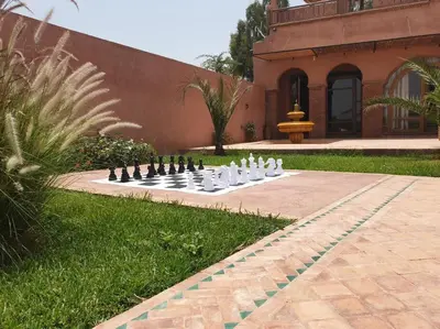 a chess board in the middle of a garden at RIAD - Jnan Bnati - Pool in Marrakech