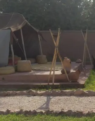 a teddy bear laying on the ground next to a tent at RIAD - Jnan Bnati - Pool in Marrakech