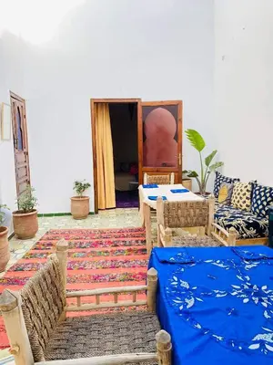 a room with couches and a table and a rug at house rose in Marrakech