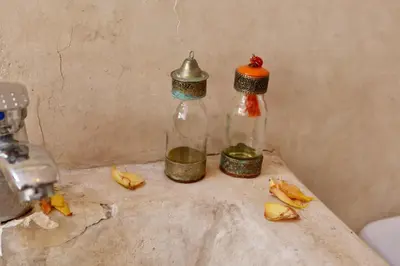 a couple of bottles sitting on a counter with bananas at house rose in Marrakech