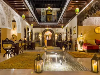 a lobby with a pool in the middle of a building at Perlekech Riad & Spa in Marrakech