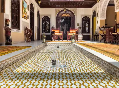 a pool in a room with a tiled floor at Perlekech Riad & Spa in Marrakech