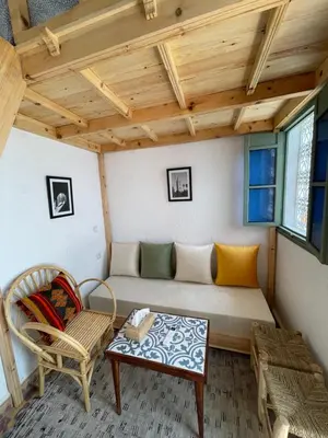 a room with a couch and a chair and a table at Riad Yu Yu in Marrakech
